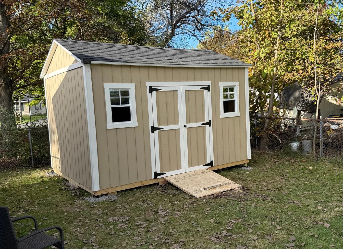 Beige 10 by 14 CNY Sheds shed with white trim and double doors in Baldwinsville
