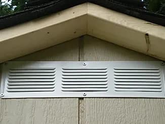 Close-up of a four-inch roof overhang and gable vent on a shed
