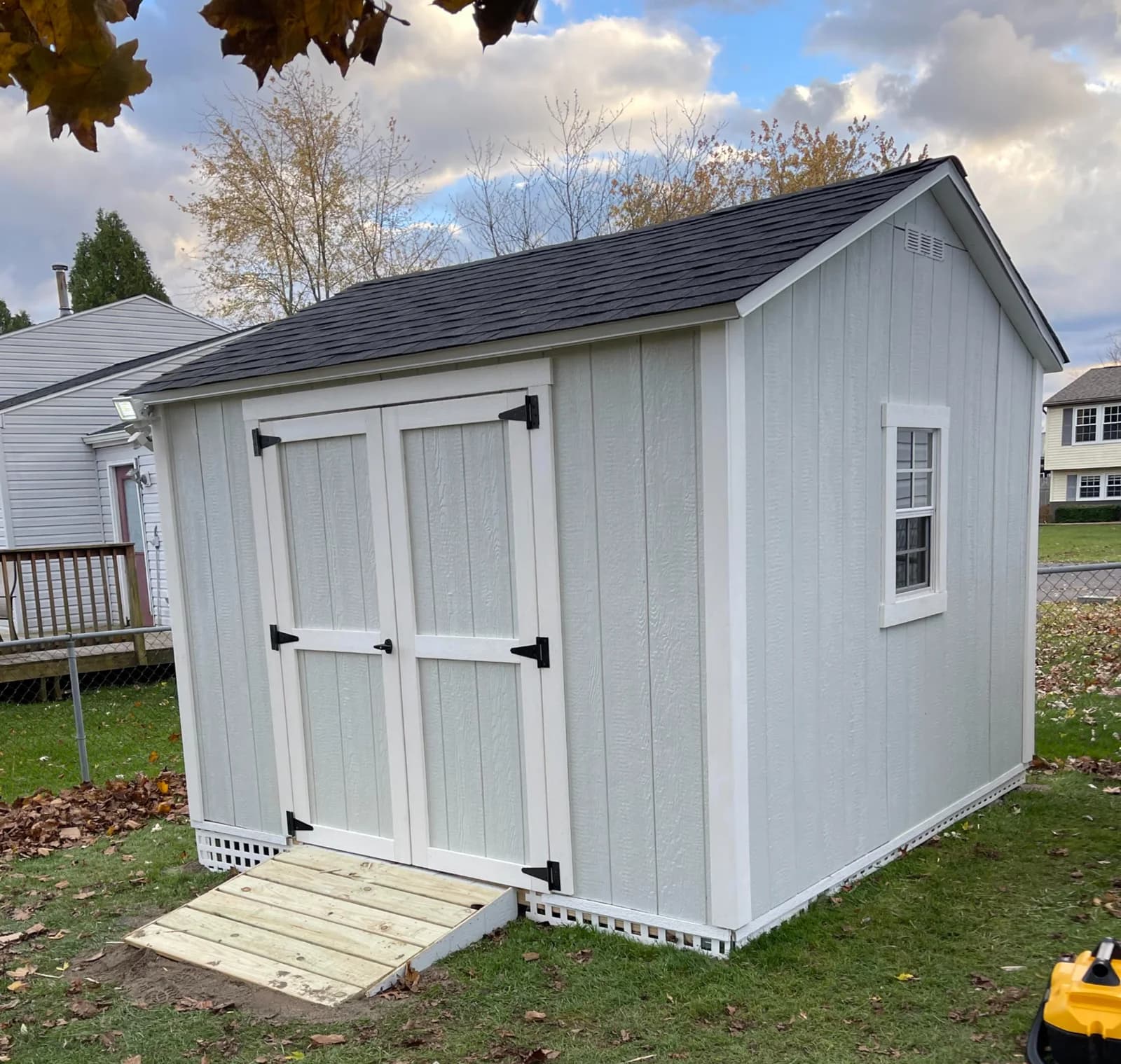 Jesse’s white 10 by 10 shed with double doors and a ramp in Clay, NY